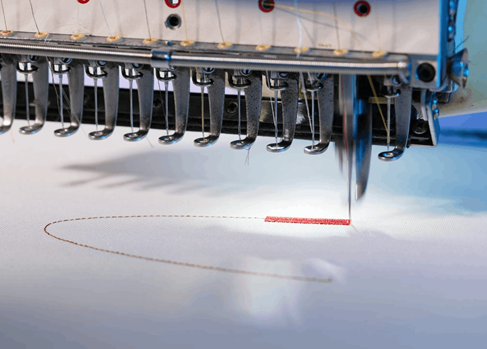 Industrial embroidery machine stitching a logo onto fabric