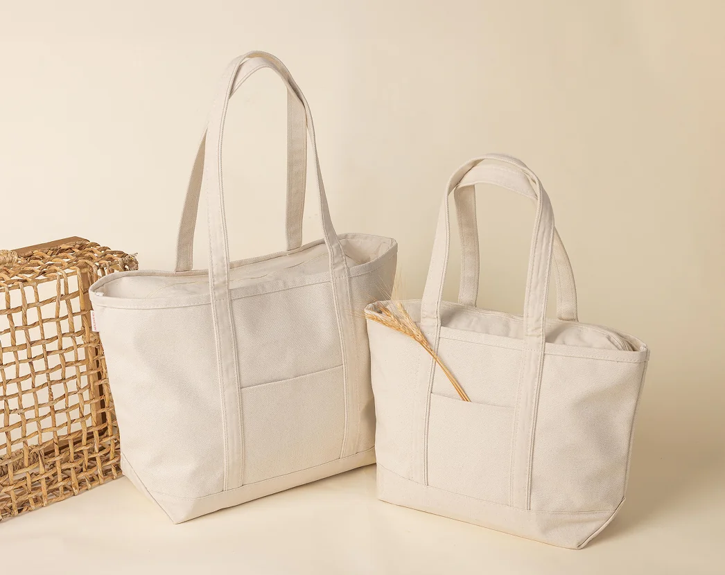 Two natural canvas tote bags on a wooden surface