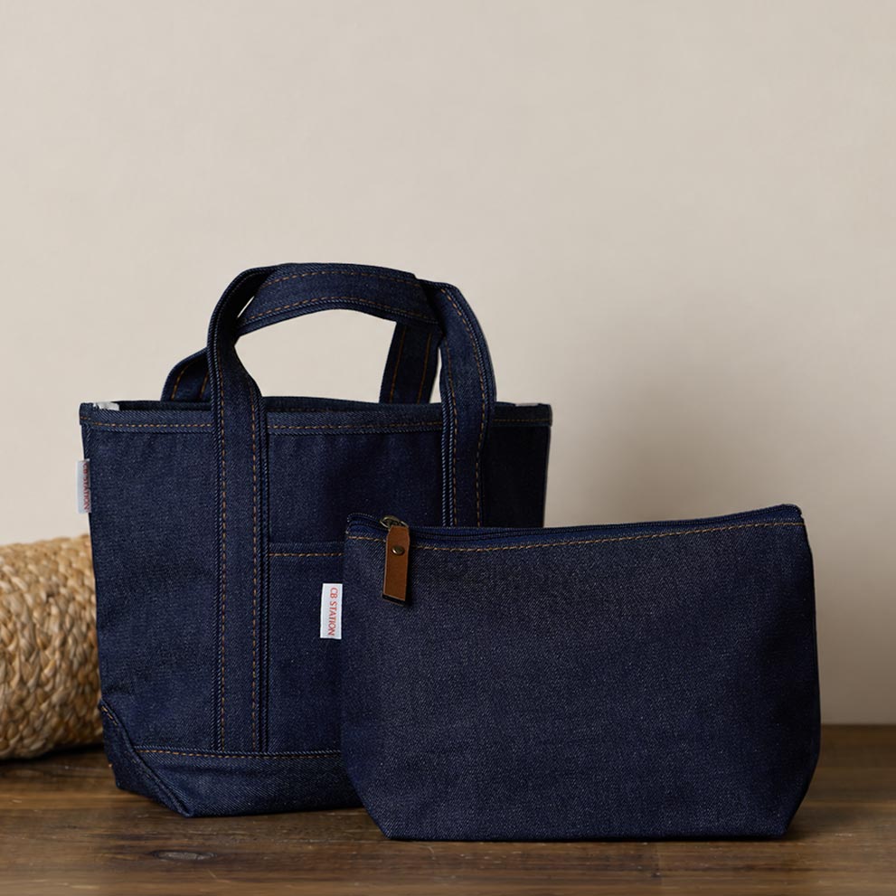 Heritage denim tote and pouch on a wooden surface