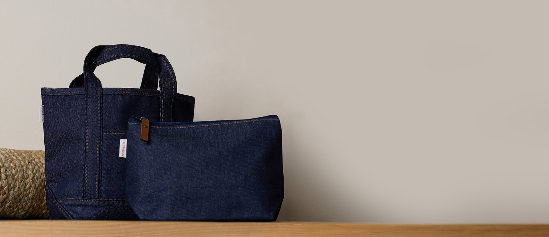 Heritage denim tote and pouch on a wooden surface