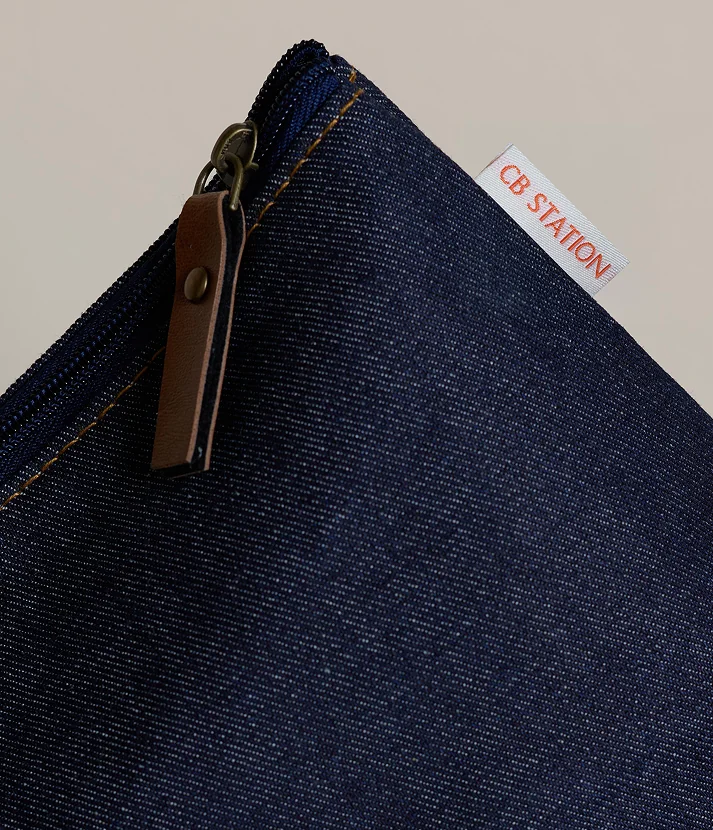 Close-up of heritage denim bag with zipper and CB Station label