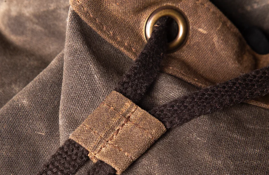 Waxed canvas grommet and leather cord hardware detail